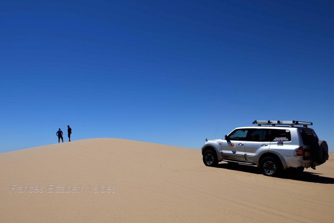 Nigel and JP from Red Dune Safaris stop and admire the view from the top of a sand dune they just taught Nigel to drive up